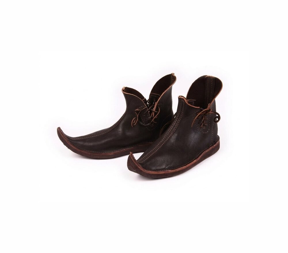 Pair of handmade dark brown medieval pointed Schnabelschuhe with laced folded collars on white background