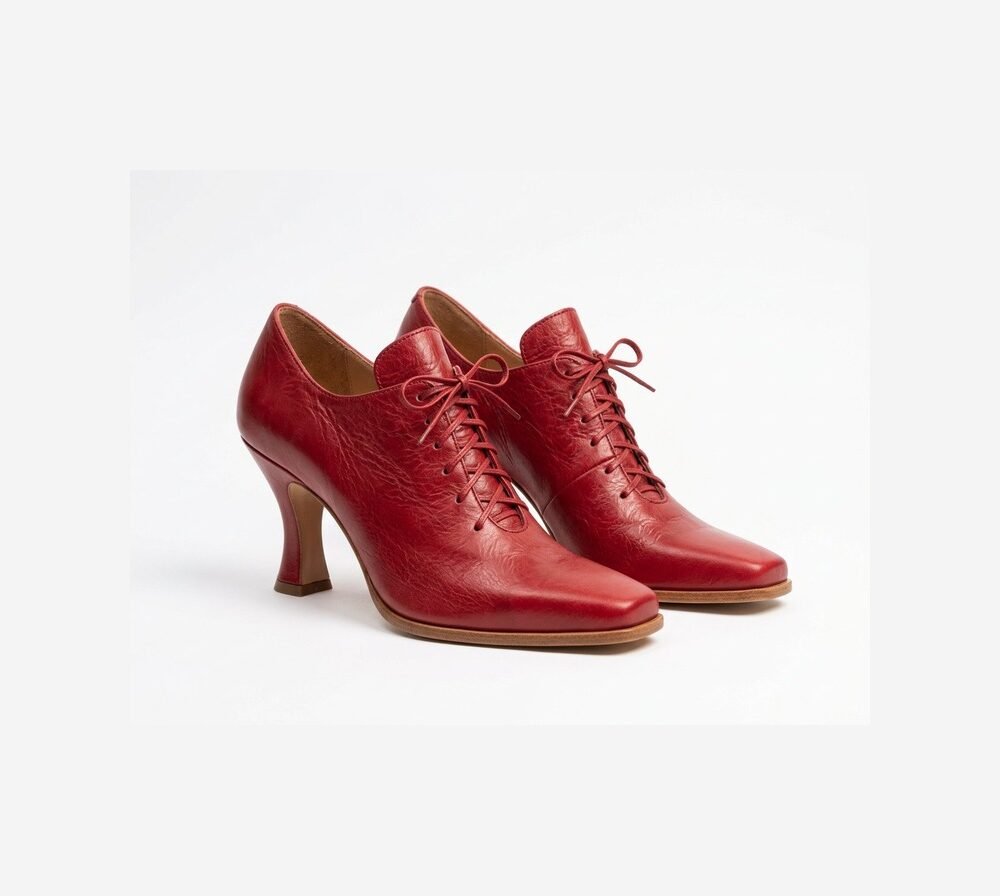 Ruby red baroque ladies shoes with corset lace-up bow and curved Louis heel — three-quarter view