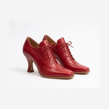 Ruby red baroque ladies shoes with corset lace-up bow and curved Louis heel — three-quarter view